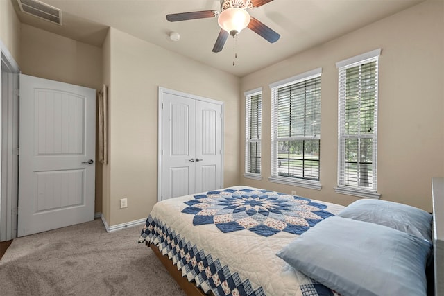 bedroom featuring a closet, ceiling fan, and light carpet