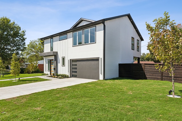 view of front of home with a front yard and a garage