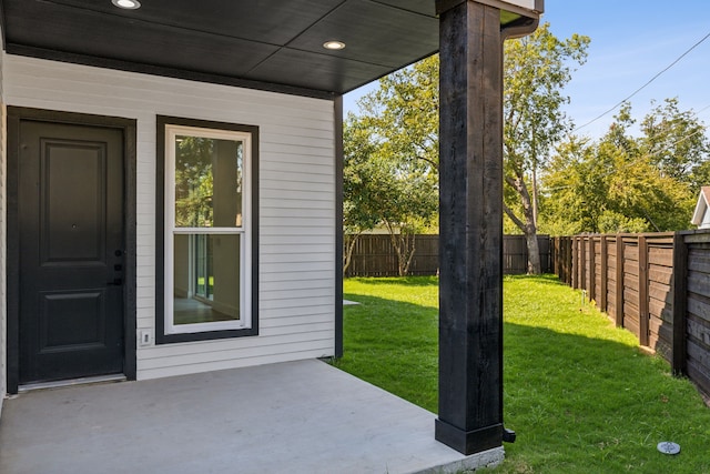 doorway to property featuring a yard and a patio