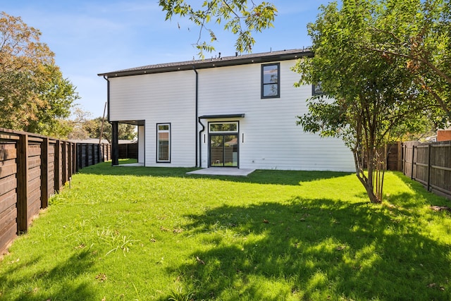 back of property featuring a lawn and a patio