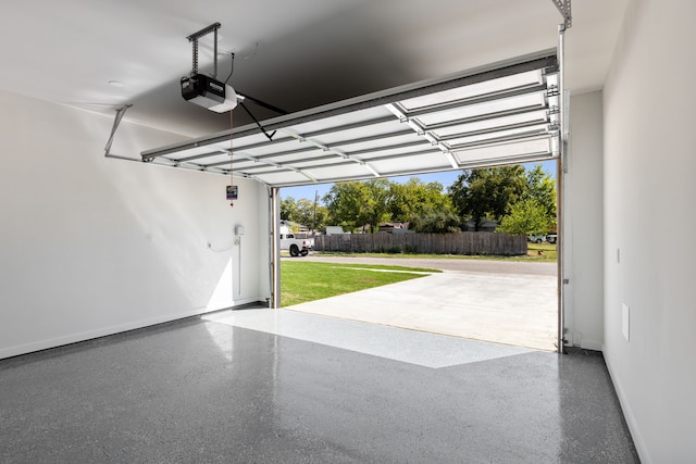 garage with a garage door opener and a lawn