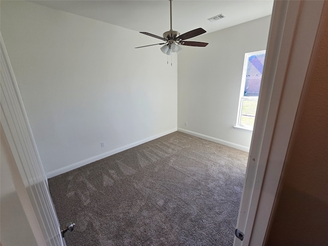 empty room with ceiling fan and carpet floors