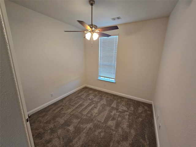 empty room with dark carpet and ceiling fan