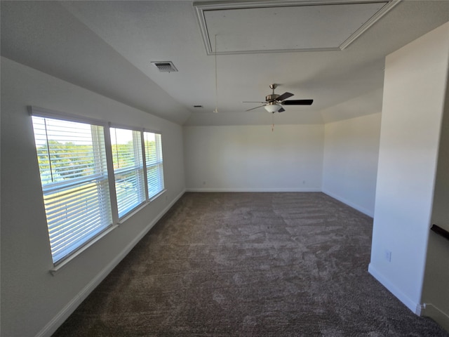 unfurnished room with dark colored carpet, ceiling fan, and lofted ceiling