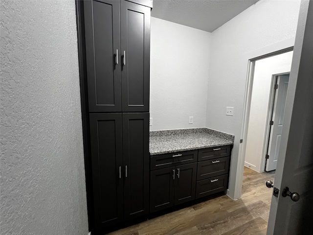 bathroom with wood-type flooring, a textured ceiling, and vanity