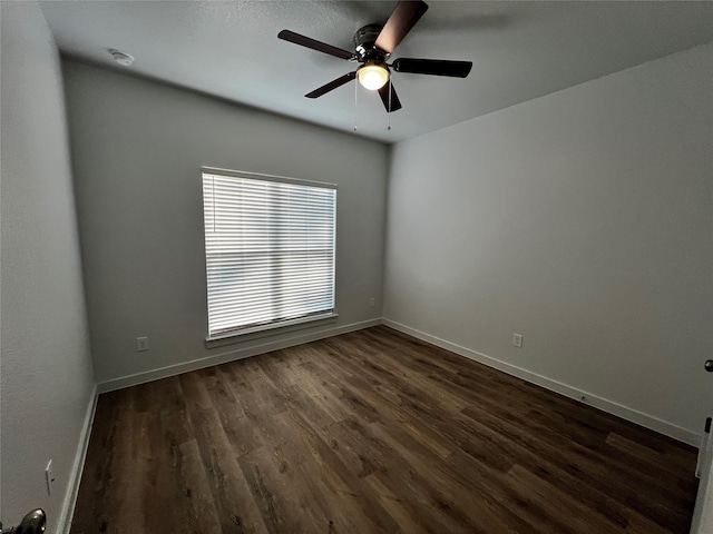 empty room with ceiling fan and dark wood-type flooring