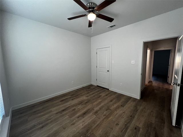 unfurnished bedroom with ceiling fan and dark hardwood / wood-style flooring