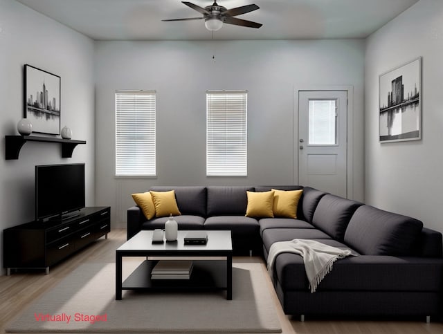 living room featuring ceiling fan and light wood-type flooring