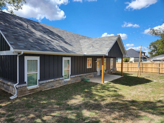 rear view of property with a patio and a yard