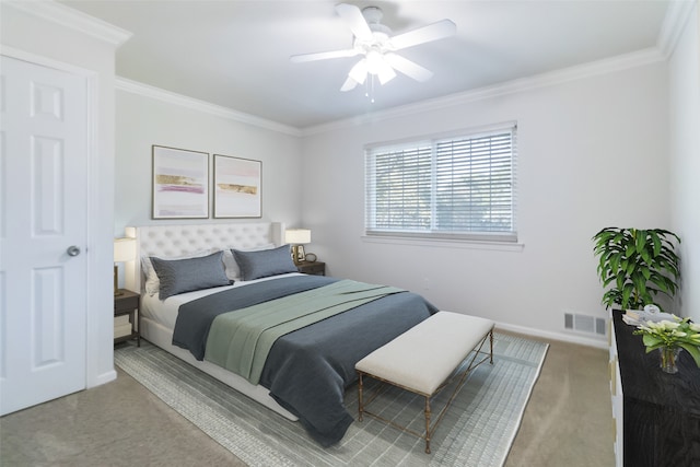 carpeted bedroom featuring ornamental molding and ceiling fan