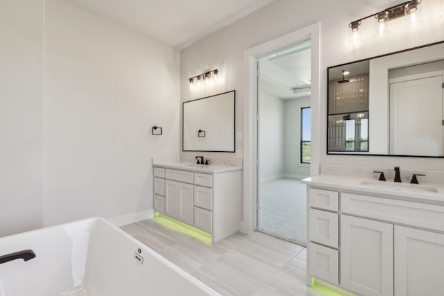 bathroom featuring vanity, a bathtub, and tile patterned flooring