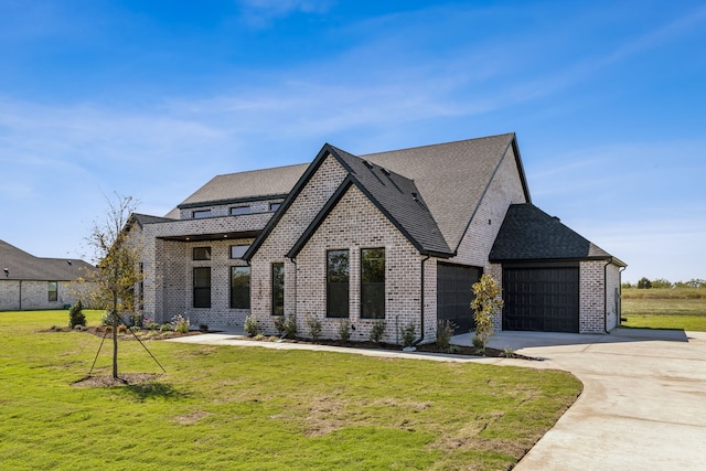 view of front of house with a front yard and a garage