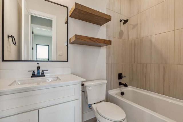 full bathroom featuring tiled shower / bath, vanity, and toilet