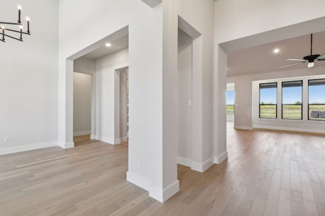 interior space with a notable chandelier and light wood-type flooring