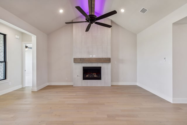 unfurnished living room with a fireplace, ceiling fan, and light hardwood / wood-style flooring