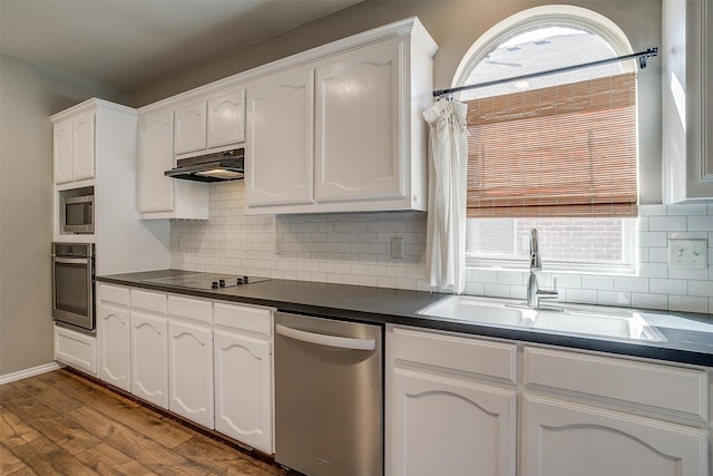 kitchen featuring wood-type flooring, appliances with stainless steel finishes, plenty of natural light, and sink