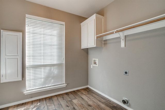 laundry room with washer hookup, cabinets, hookup for an electric dryer, and light hardwood / wood-style flooring