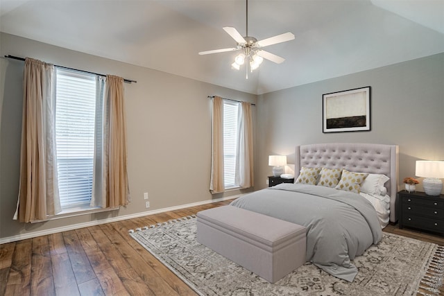 bedroom with ceiling fan, vaulted ceiling, and hardwood / wood-style floors