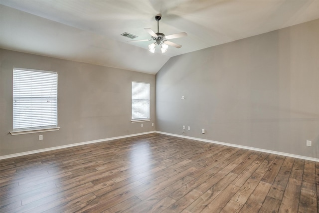 unfurnished room with ceiling fan, lofted ceiling, plenty of natural light, and dark hardwood / wood-style floors