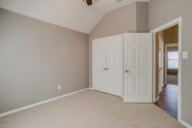 unfurnished bedroom with ceiling fan, lofted ceiling, a closet, and light hardwood / wood-style flooring