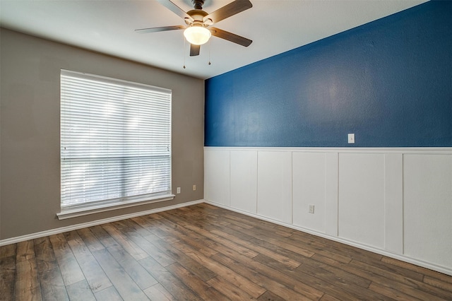 spare room featuring ceiling fan and dark hardwood / wood-style floors