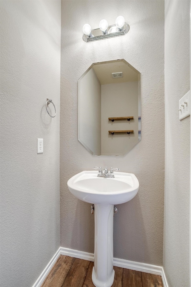 bathroom featuring sink and hardwood / wood-style floors