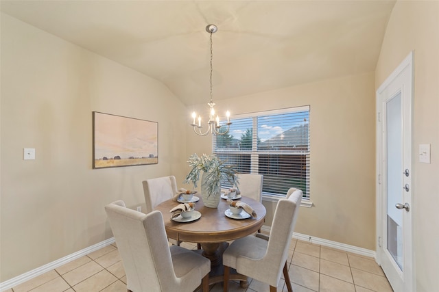 tiled dining space featuring lofted ceiling and a chandelier