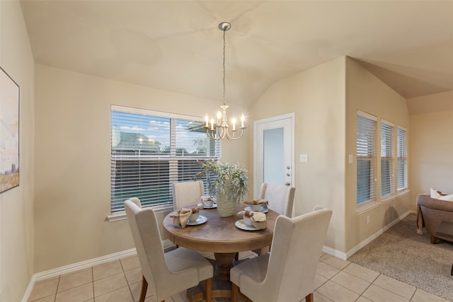 tiled dining room featuring lofted ceiling and an inviting chandelier