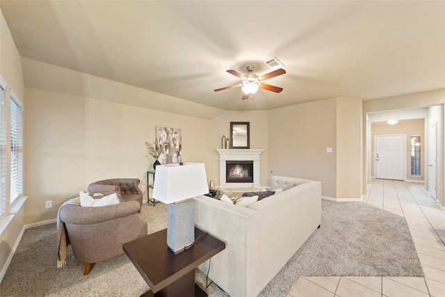 living room with ceiling fan and light tile patterned flooring