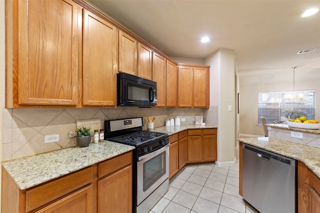 kitchen with light stone countertops, backsplash, appliances with stainless steel finishes, and an inviting chandelier