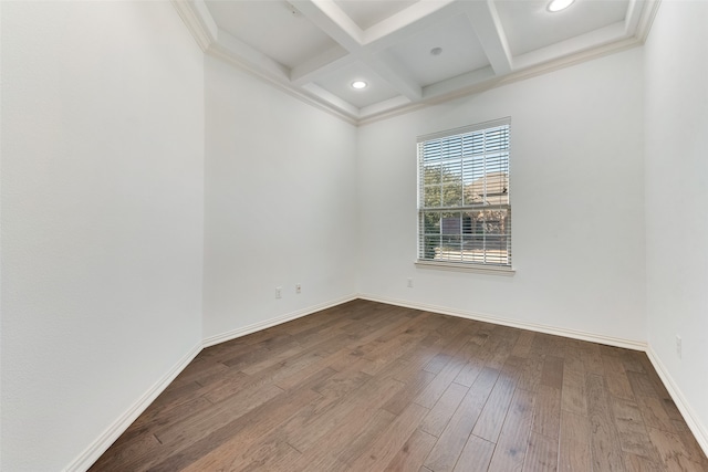 spare room featuring coffered ceiling, beam ceiling, hardwood / wood-style flooring, and ornamental molding