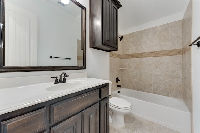 full bathroom featuring vanity, tiled shower / bath combo, toilet, and tile patterned flooring