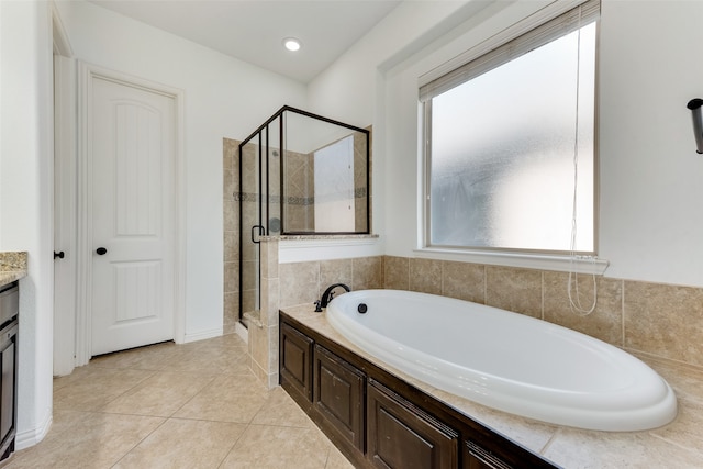 bathroom featuring tile patterned flooring, separate shower and tub, and vanity