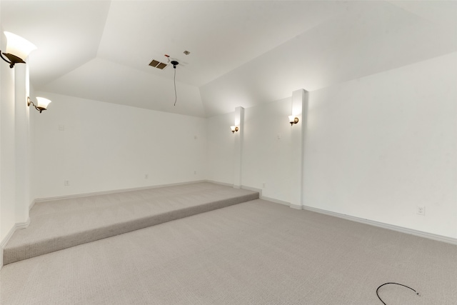 unfurnished room with vaulted ceiling and carpet flooring