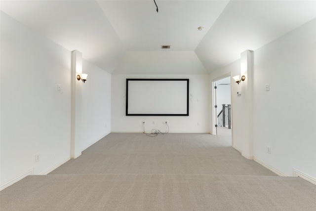 carpeted cinema room with lofted ceiling