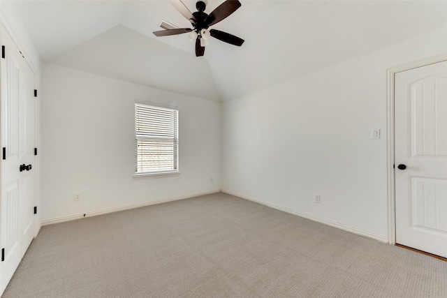 carpeted empty room with ceiling fan and lofted ceiling