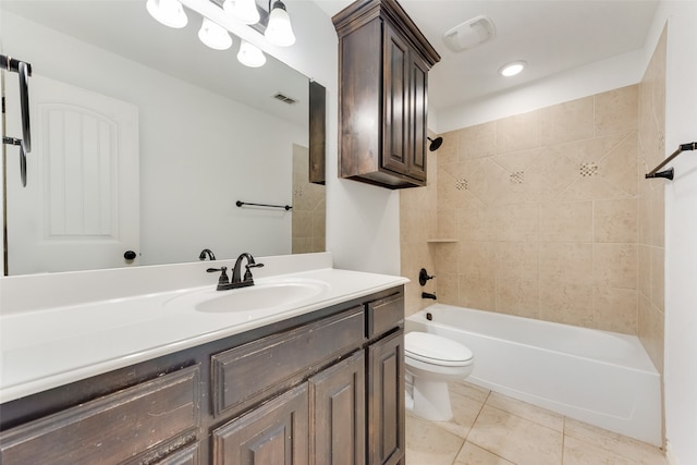 full bathroom with vanity, tile patterned flooring, toilet, and tiled shower / bath combo