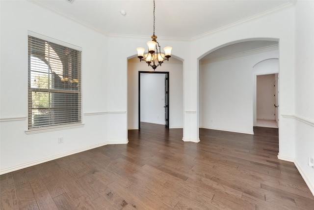 unfurnished room featuring an inviting chandelier, dark hardwood / wood-style floors, and crown molding