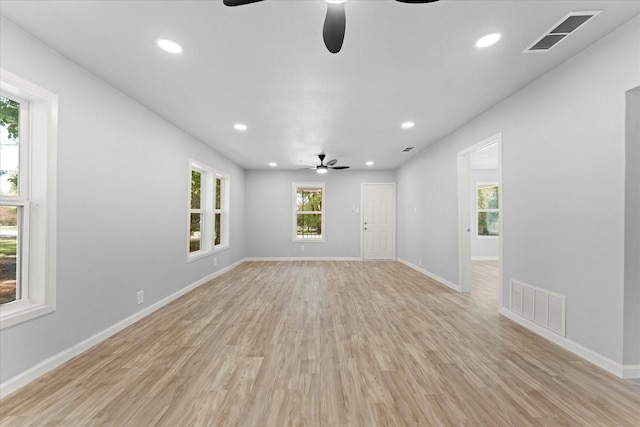 empty room with recessed lighting, visible vents, light wood-style flooring, and baseboards