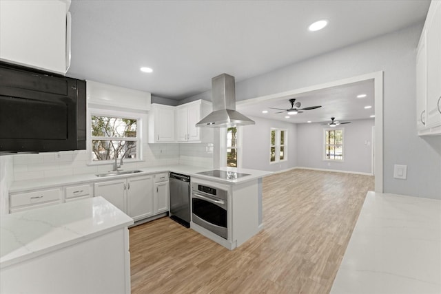 kitchen featuring oven, black electric cooktop, a sink, wall chimney range hood, and dishwashing machine