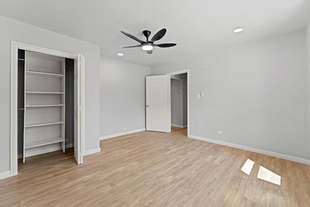 unfurnished bedroom with a closet, recessed lighting, light wood-style flooring, and baseboards