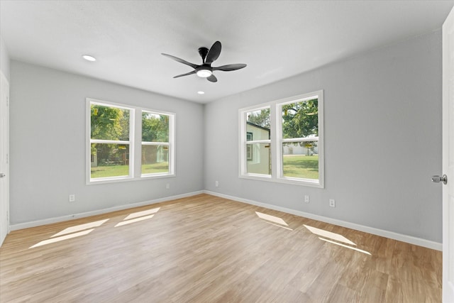 empty room featuring recessed lighting, ceiling fan, light wood-style floors, and baseboards