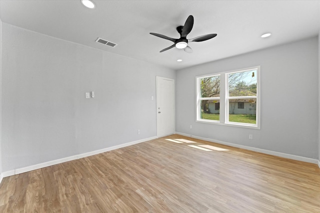 spare room featuring light wood finished floors, visible vents, recessed lighting, and baseboards