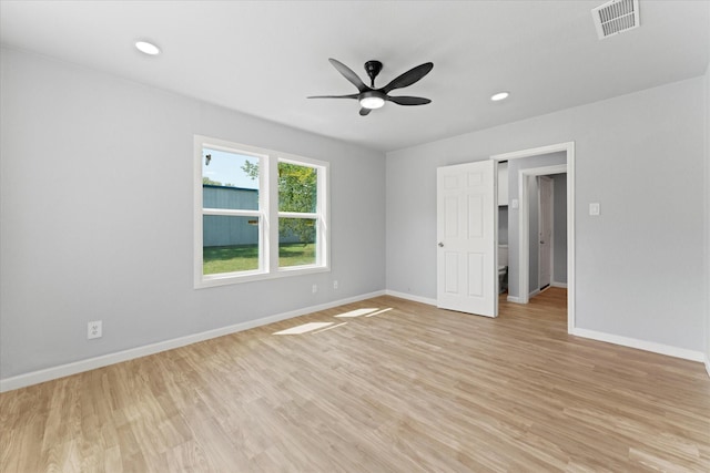 spare room with visible vents, baseboards, and light wood-style floors