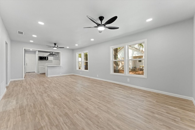 unfurnished living room with recessed lighting, baseboards, light wood-style floors, and a ceiling fan