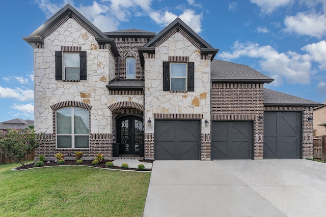 view of front of house with a front lawn and a garage