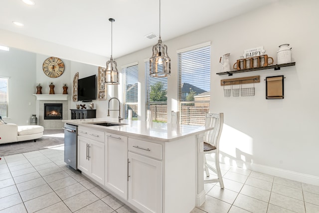 kitchen featuring a center island with sink, plenty of natural light, white cabinetry, and sink