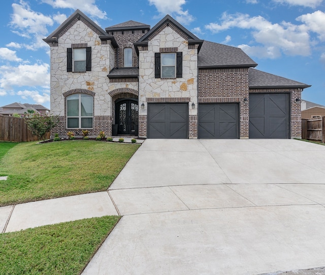 view of front of house with a garage and a front lawn