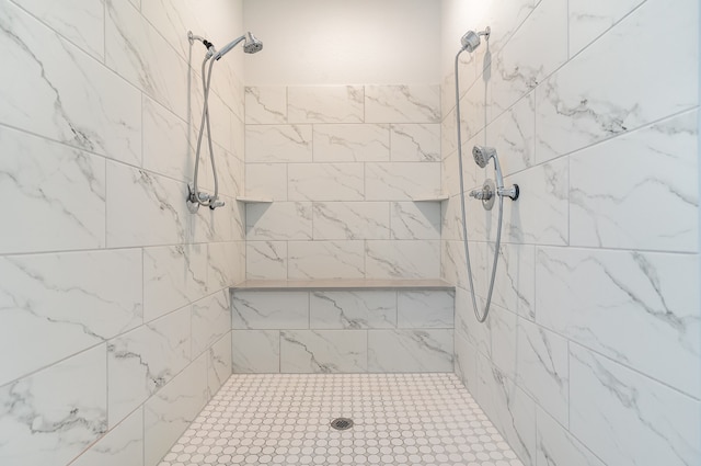 bathroom with a tile shower