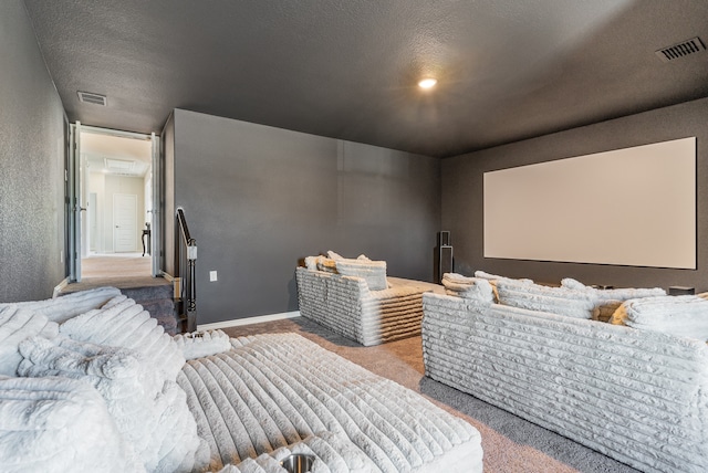 home theater room with a textured ceiling and carpet flooring